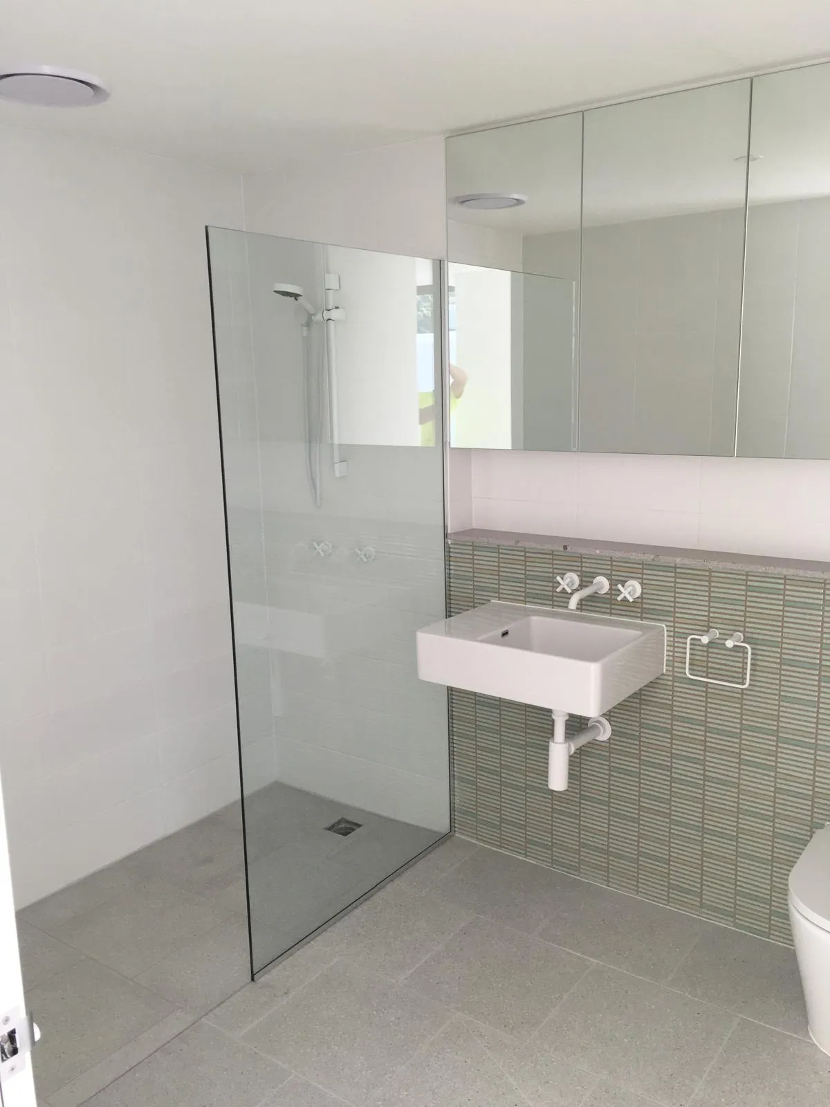 Bathroom with glass shower screen and wall-mounted basin
