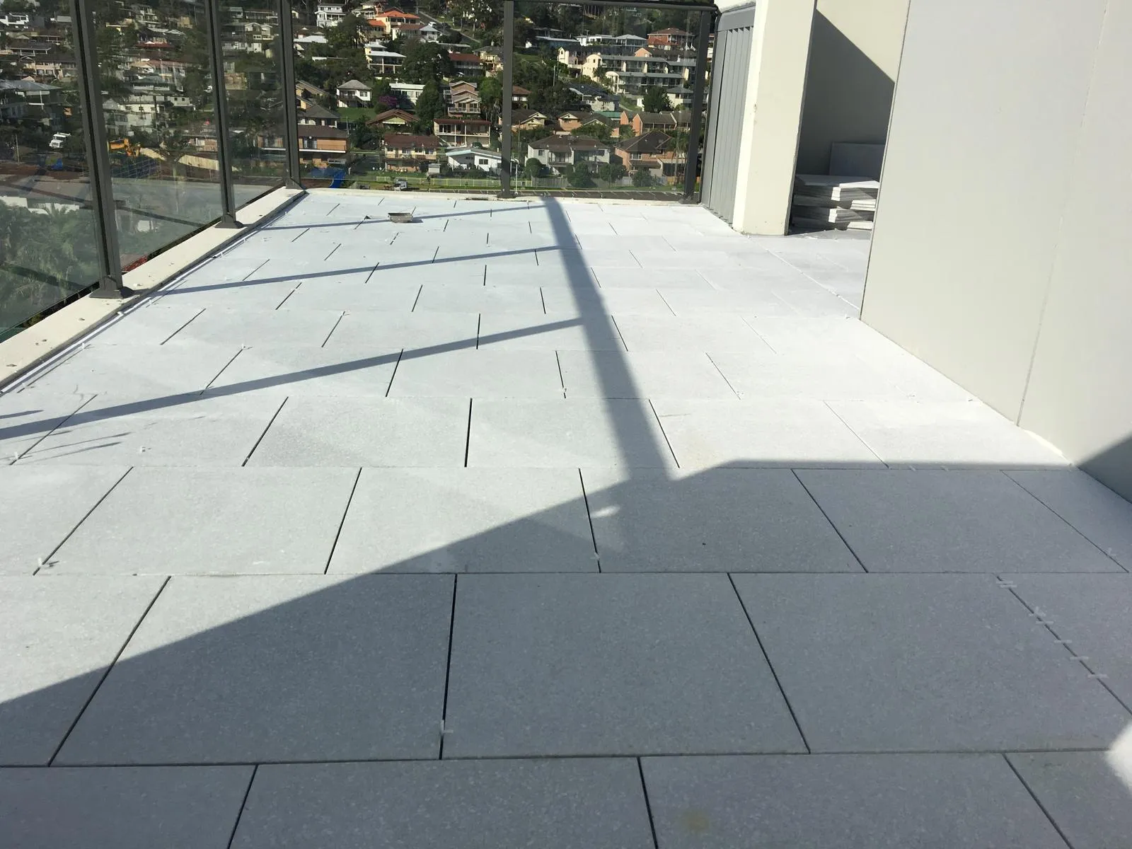 Light tiled outdoor terrace in direct sunlight